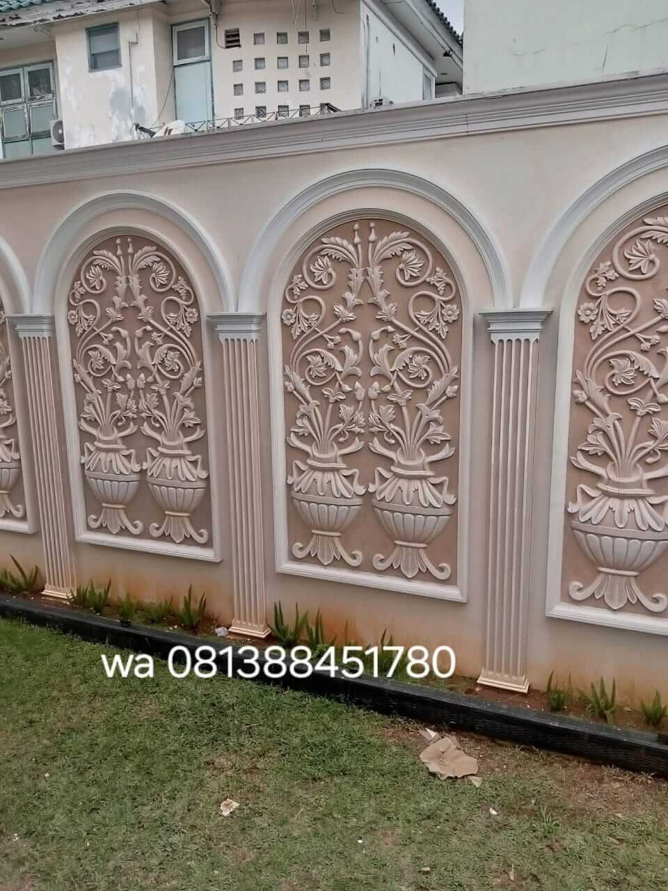 Panel relief yang memberi ritme pada bidang pagar.
